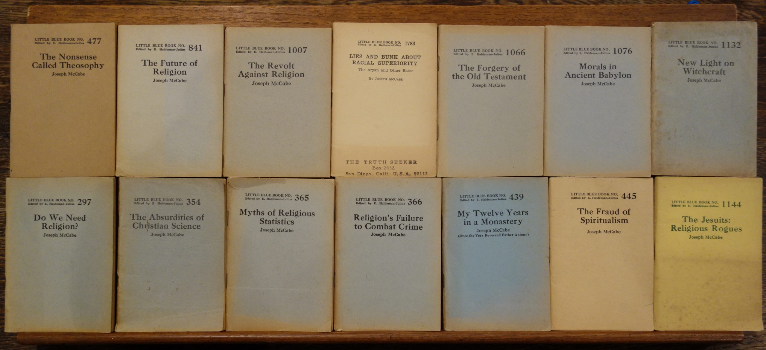 A colour photograph of a selection of Little Blue Books By Joseph McCabe