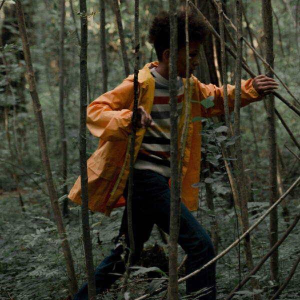 This image shows a child running through a forest